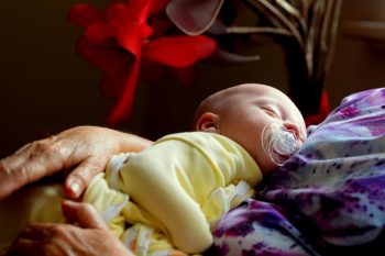 When should you transition from swaddle to sleep sack or sleeping bag?