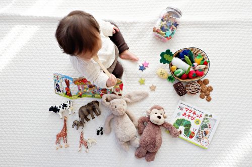 baby surrounded by baby things in their new room