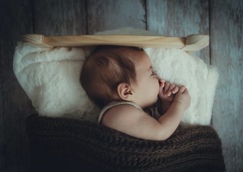 sleeping baby in little bed