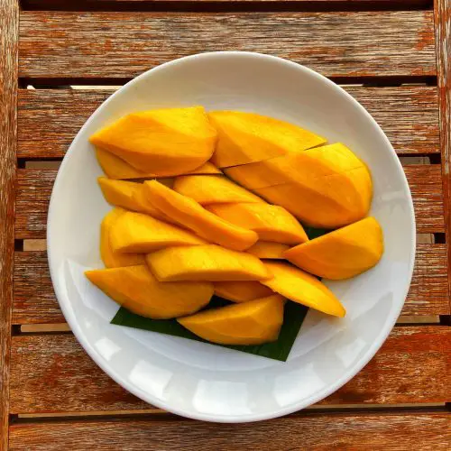 sliced mango on white ceramic bowl