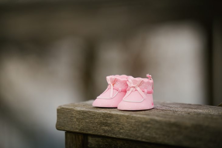  pink shoes on wooden bench