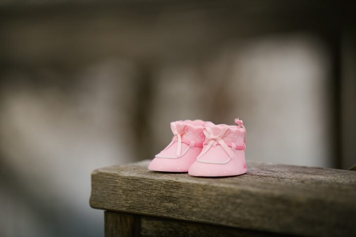 pink shoes on wooden bench