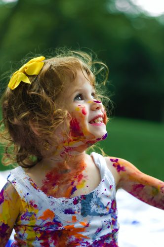 toddler girl playing with paint