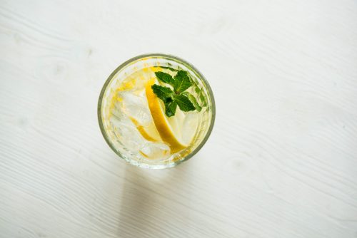 Top view of a glass of water with lemon