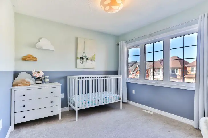 white wooden bed crib frame in blue and white room