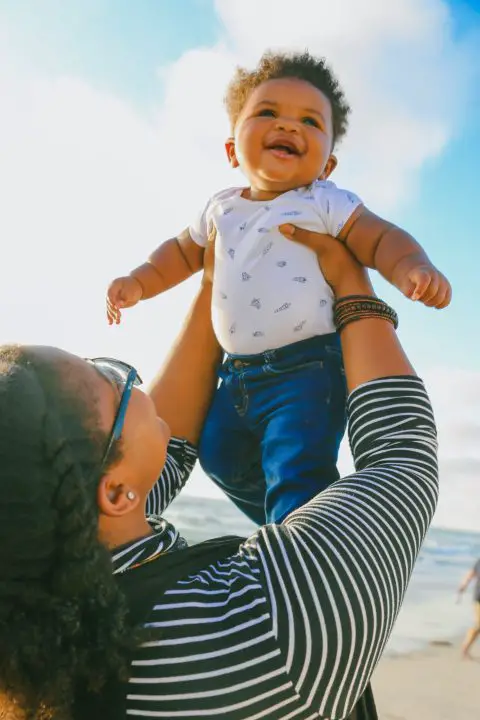 baby and mom at a beach