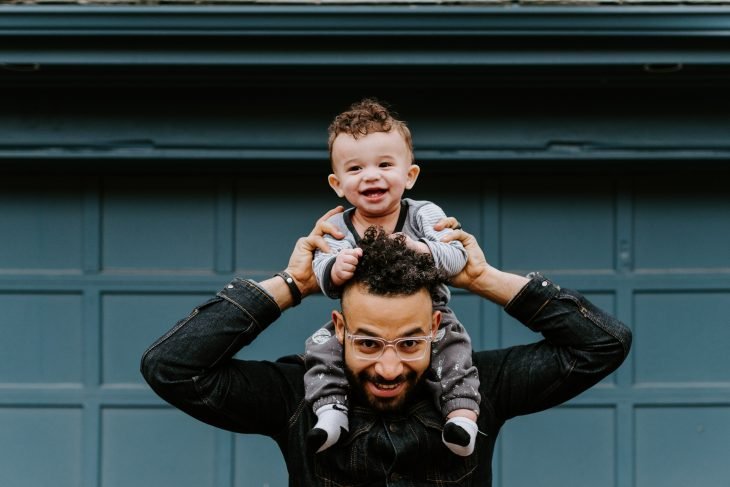 Father holding his baby son on his shoulders