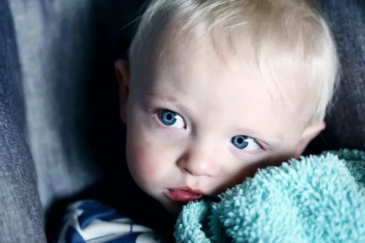 Portrait of a curious baby looking away.