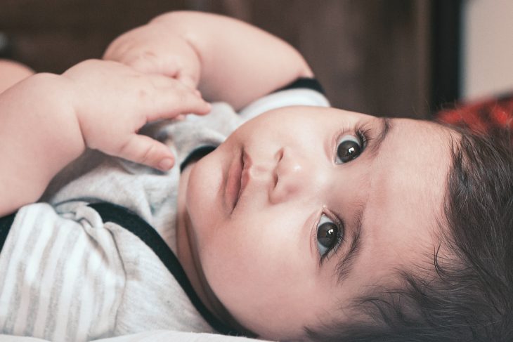 sourena , boy looking up , cute baby on bed