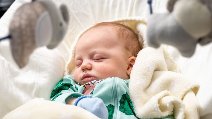 baby sleeping in baby swing