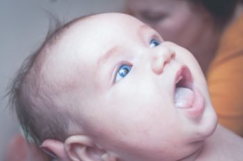 baby sucking on lower lip