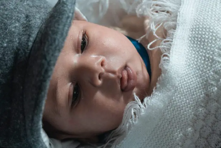 baby sucking on lower lip