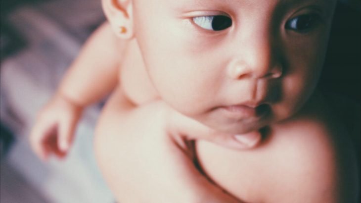 baby sucking on lower lip