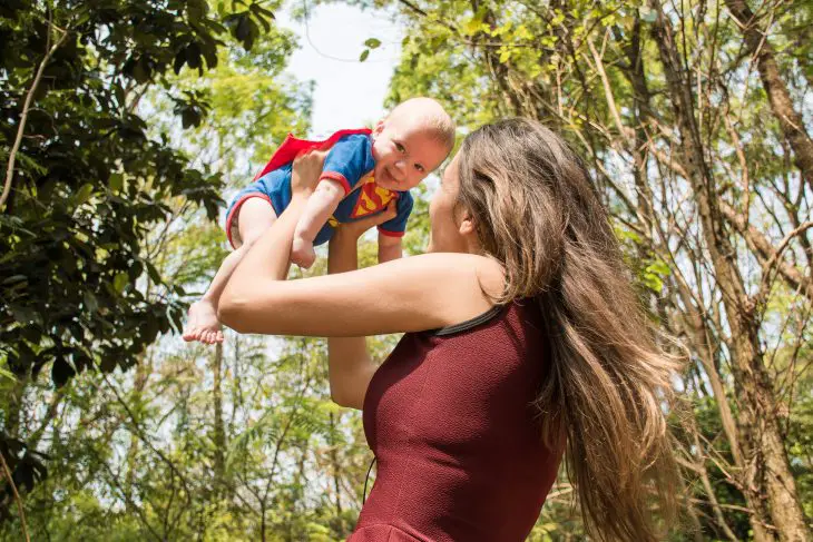 Superman baby flying in the forest