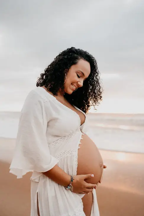 pregnant woman in white long sleeve shirt 